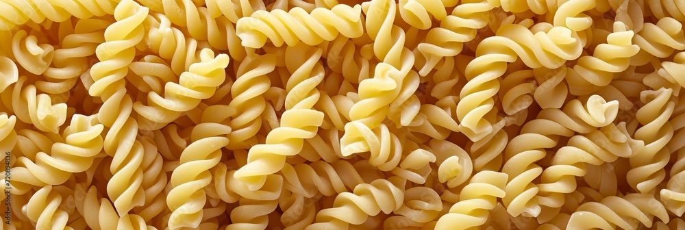 Close up top view of traditional italian pennettine pasta as abstract background texture Close up top view of traditional italian pennettine pasta as abstract background texture