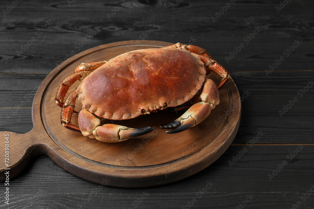 Delicious boiled crab on black wooden table Delicious boiled crab on black wooden table