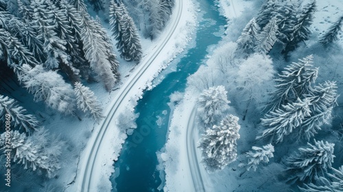 Aerial top view of snow road winter time over blue river © Zaria