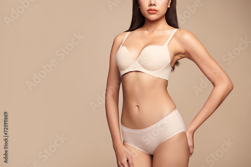 Confident beautiful young asian woman posing in white lingerie on beige background, Perfect body,