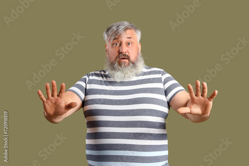 Afraid mature man on green ...