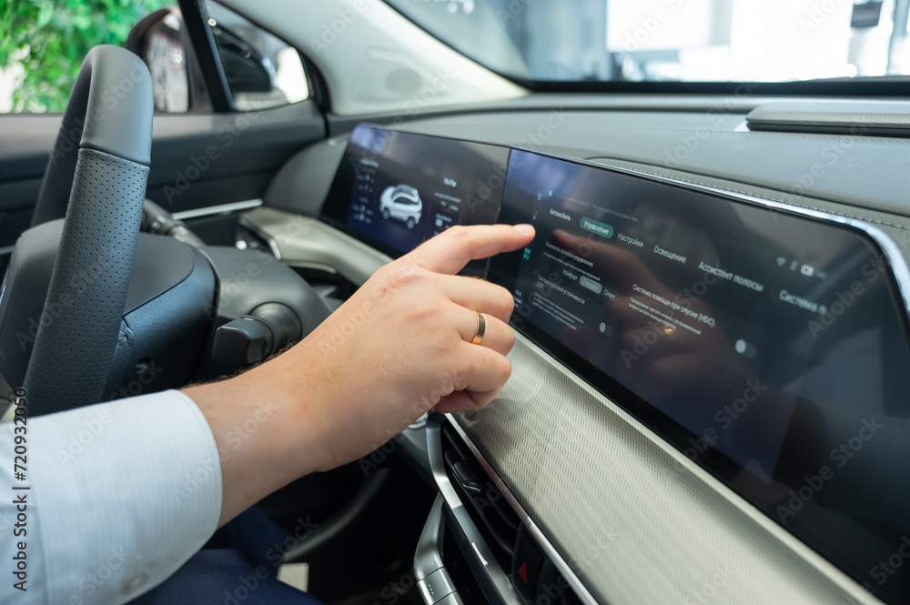Close-up of a man's hands on the dashboard of a modern car. Close-up of a man's hands on the dashboard of a modern car.