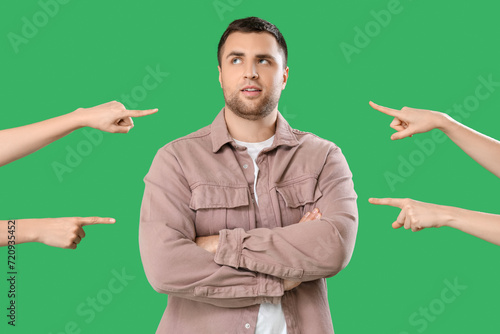People pointing at young ma...