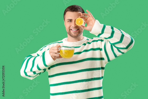 Young man with glass cup of...