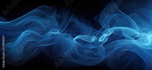 This photo shows a textured blue smoke billowing against a black background.