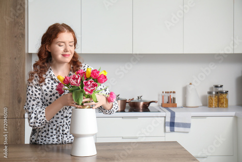 Young woman and vase with b...