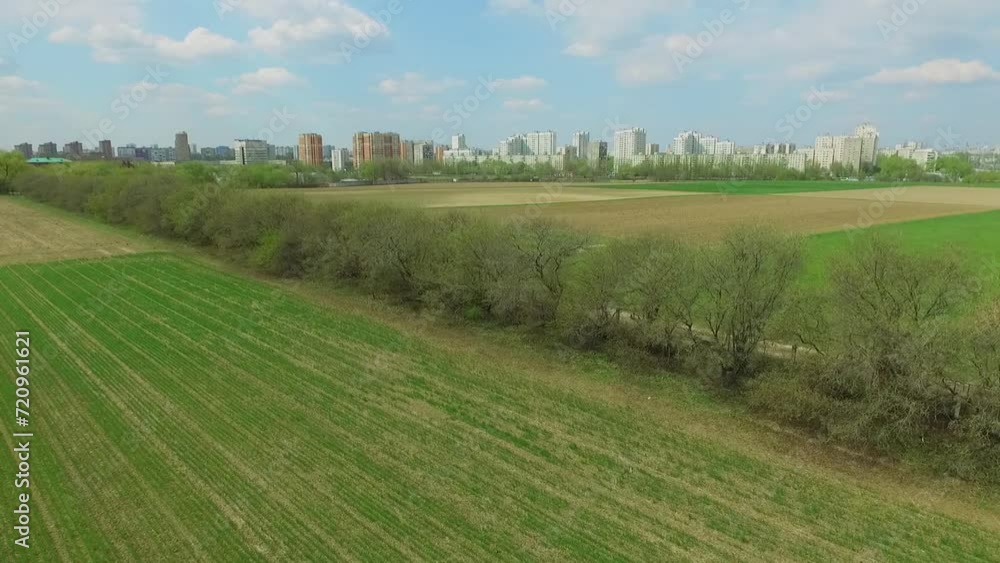 Cityscape and experimental grass fields at spring sunny day Cityscape and experimental grass fields at spring sunny day