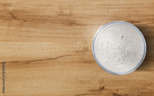 Milk in a glass on a wooden table