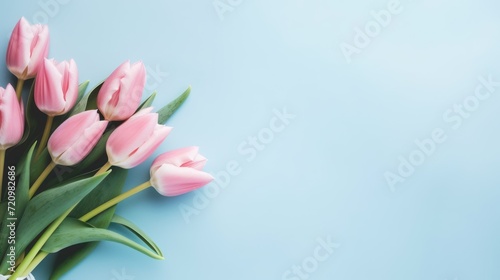 Bouquet of pink tulips on blue background. Flat lay  top view Generative AI