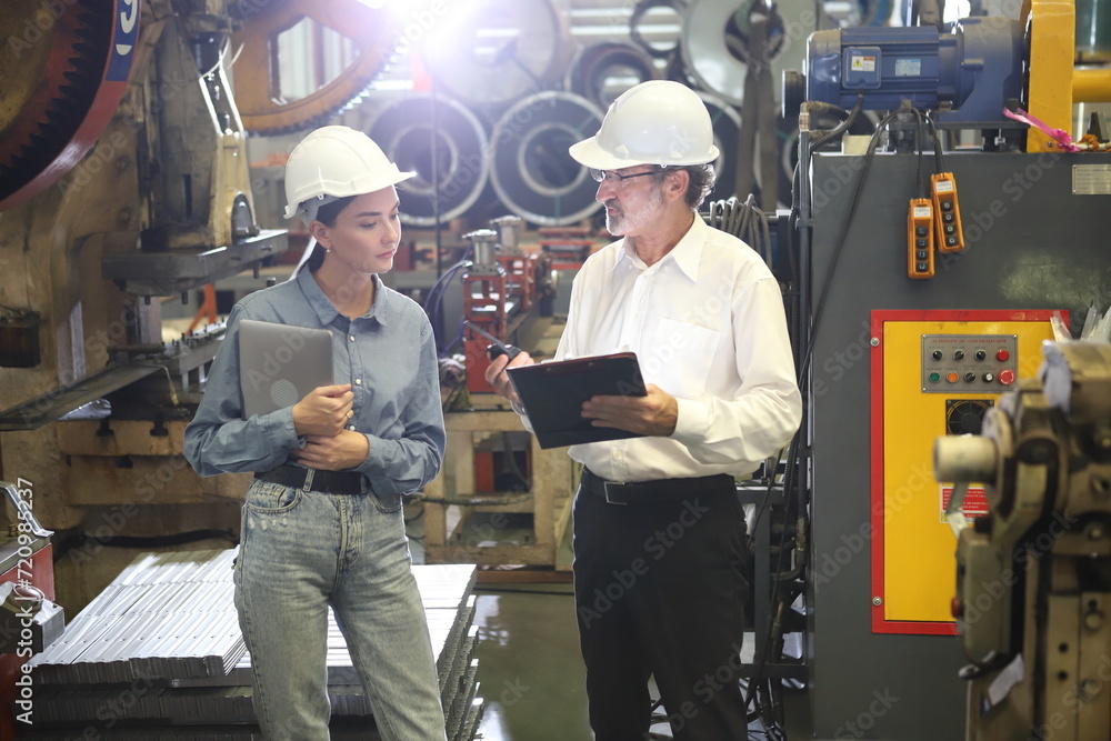 worker or engineer working in factory with safety uniform , safety hat and safety glasses , image is safety concept or happy workplace worker or engineer working in factory with safety uniform , safety hat and safety glasses , image is safety concept or happy workplace
