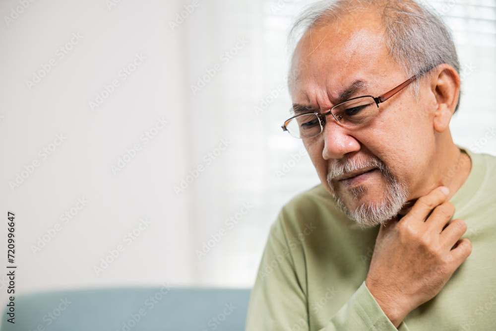 Retirement senior man feeling pain use hands holding neck and irritation in throat, Elderly people have dysphagia due to eating, Asian old man painful in sore throat, Health care and medicine concept Retirement senior man feeling pain use hands holding neck and irritation in throat, Elderly people have dysphagia due to eating, Asian old man painful in sore throat, Health care and medicine concept