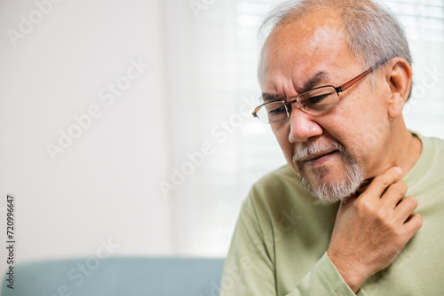 Retirement senior man feeling pain use hands holding neck and irritation in throat, Elderly people have dysphagia due to eating, Asian old man painful in sore throat, Health care and medicine concept