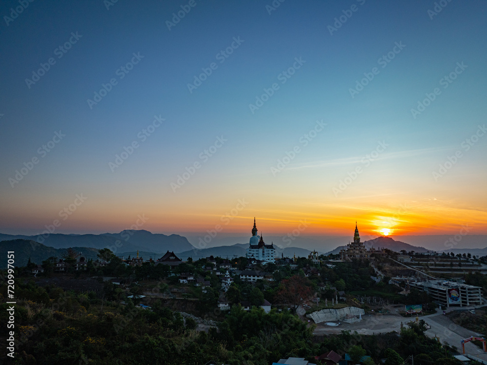 Aerial view beautiful sunrise above Big White Five buddha Statues in Wat Phra That Pha Son Kaew temple at Phetchabun Thailand..beautiful and famous landmark in Thailand. sea of mist background. .