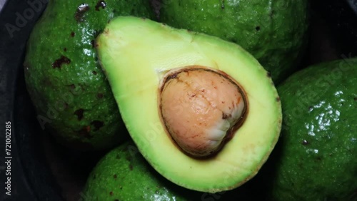 Avocado slice with rotating background. Top view concept.