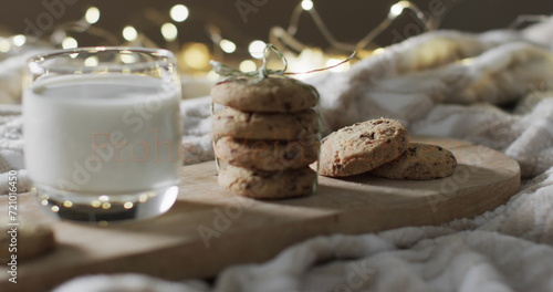 A glass of milk and cookies on a cozy blanket, with copy space
