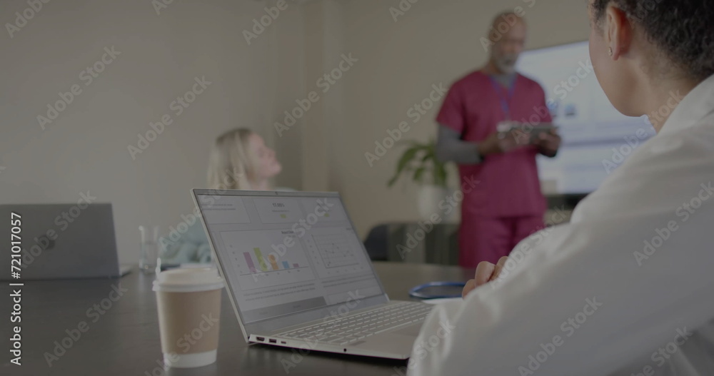 Obraz premium Image of financial data processing over diverse doctors in office