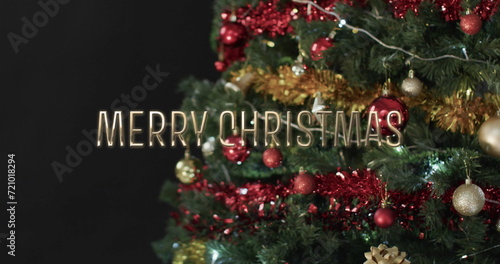 Merry christmas text over decorated christmas tree and gifts on black background
