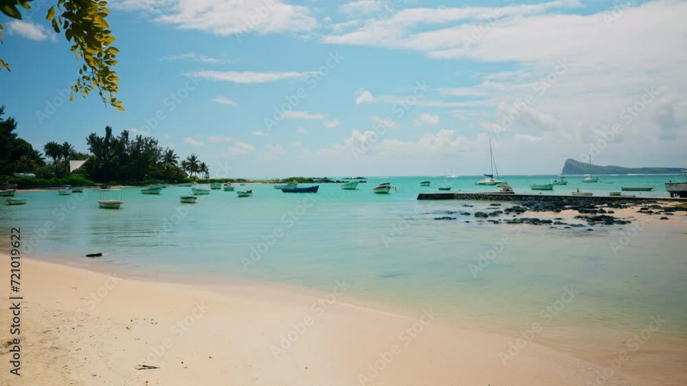 Tropical empty beach. Small wooden fishing boats anchored close to the shore. Unspoiled exotic beach. Mauritius Island, Indian Ocean. Tropical empty beach. Small wooden fishing boats anchored close to the shore. Unspoiled exotic beach. Mauritius Island, Indian Ocean.