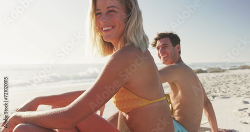 Caucasian couple enjoys a sunny beach day, with copy space