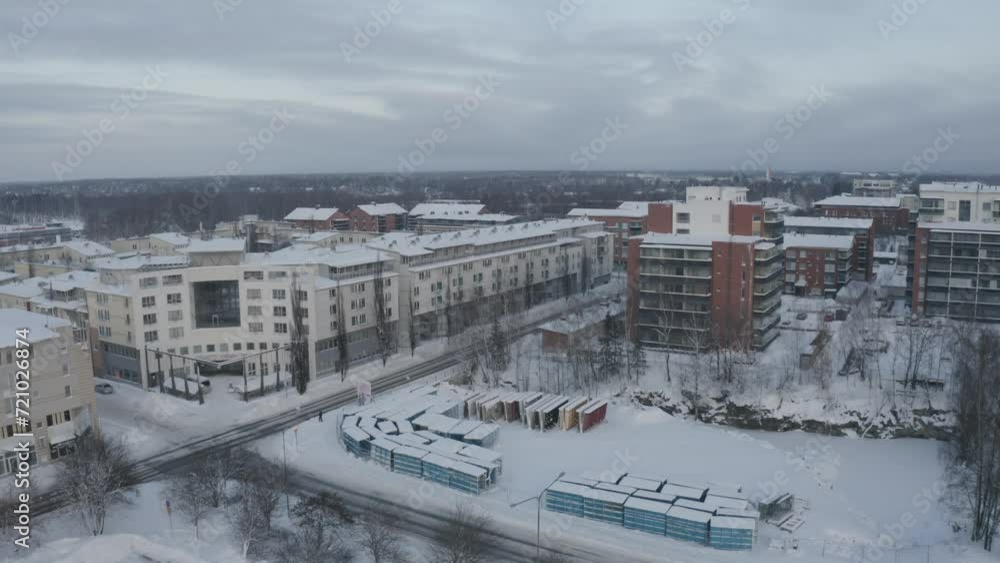 Aerial view of a cityscape covered with the snow on a cloudy day Aerial view of a cityscape covered with the snow on a cloudy day