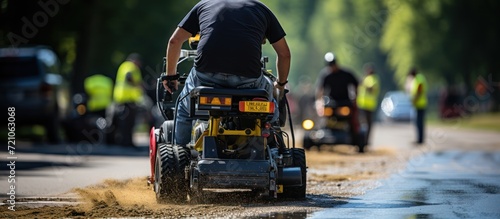 rear view Road workers use a hot melt machine to paint dividing lines on the road surface
