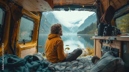 Traveler enjoying serene lake view from cozy van interior; concept of wanderlust and vanlife