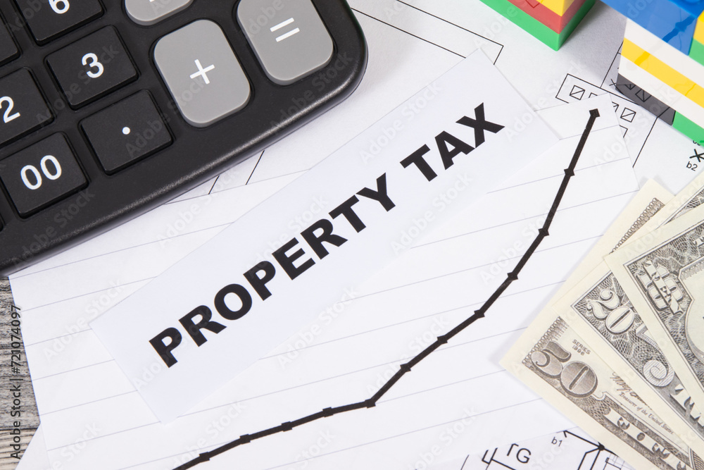 House made of toy blocks, calculator, dollar banknotes and rising graph showing real estate taxation increases. Calculating and paying tax House made of toy blocks, calculator, dollar banknotes and rising graph showing real estate taxation increases. Calculating and paying tax