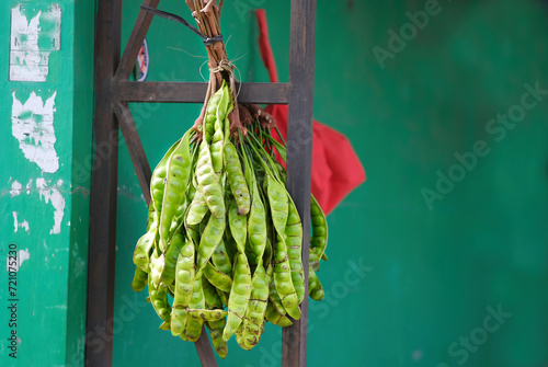 Bunch of fresh tropical stinky beans at traditional market in Indonesia