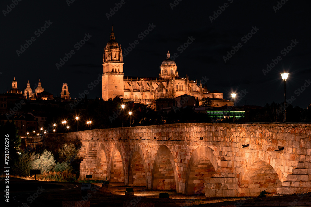 Night view of Salamanca cathedral and Roman bridge over Tormes river , Salamanca, Spain.