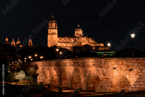 Night view of Salamanca cathedral and Roman bridge over Tormes river , Salamanca, Spain.
