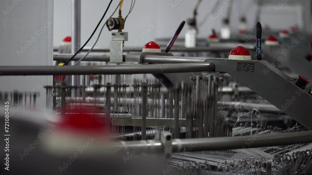 This stock video shows the operation of a loom in a weaving factory. This video will decorate your projects related to the production of fabrics, weaving factories, industry. This stock video shows the operation of a loom in a weaving factory. This video will decorate your projects related to the production of fabrics, weaving factories, industry.