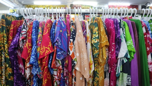 Various colored textile hang on rack in the store for sale, colorfull background