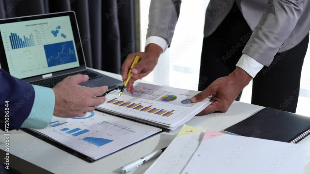 Businessman analyzing cost graphs in a conference room with a calculator and laptop with the new project of finance and accounting Presenting ideas and strategic plans at investment meetings. Businessman analyzing cost graphs in a conference room with a calculator and laptop with the new project of finance and accounting Presenting ideas and strategic plans at investment meetings.
