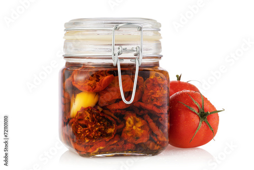 Jar of sun-dried tomatoes isolated on white background photo
