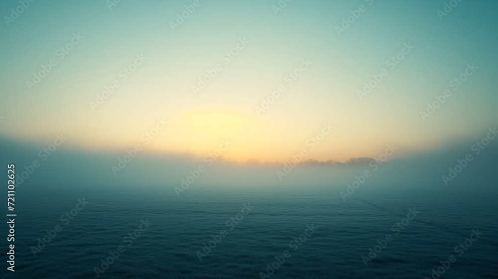 Obraz premium Tranquil sunrise over a misty, open field.