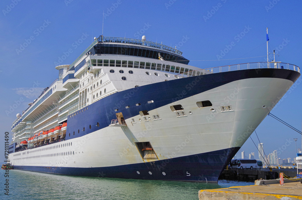 Naklejka premium Cruiseship cruise ship liner Infinity in port with harbor infrastructure moored to pier