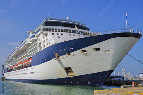 Cruiseship cruise ship liner Infinity in port with harbor infrastructure moored to pier