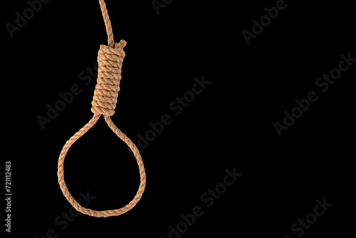 Rope noose for hangman, natural fiber rope on black background. A noose of hemp rope for killing or committing suicide. Rope knot for the gallows.