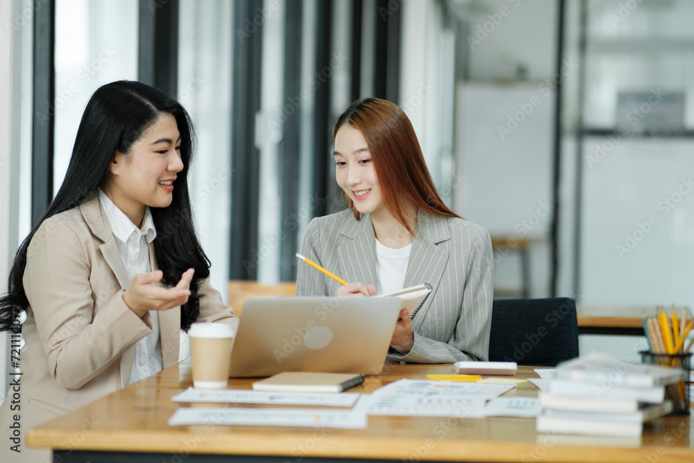 Two business women are discussing the work they have done together and exchanging ideas. To work to develop the business better. Two business women are discussing the work they have done together and exchanging ideas. To work to develop the business better.