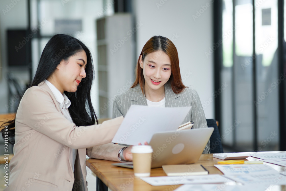 Two business women are discussing the work they have done together and exchanging ideas. To work to develop the business better. Two business women are discussing the work they have done together and exchanging ideas. To work to develop the business better.