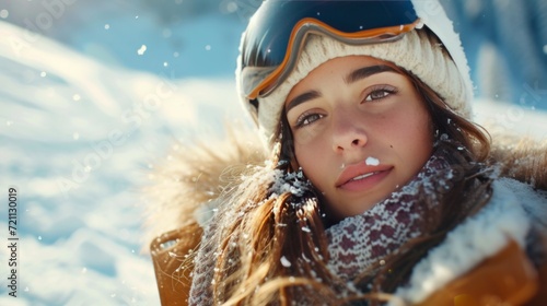 A young beautiful girl rides a snowboard and sunbathes