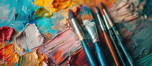 Art supplies and fresh water on a flowered tablecloth.