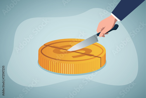 Business profit sharing, hand holding a knife to cut gold coins.Equal distribution