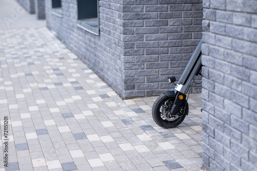 A wheelchair with an assistive device for manual control comes around the corner. Electric hand bike.