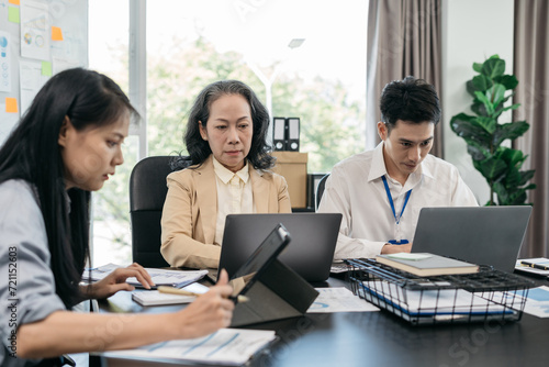 Group of Young Asian business team creative businesspeople coworker in office. Meeting Presentation for analysis graph company financial. People Work in Business Office.