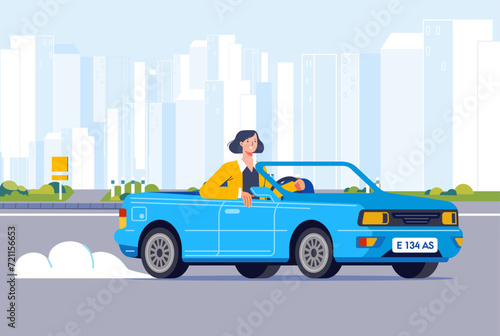 Businesswoman driving cabriolet car on road across suburb along cityscape buildings