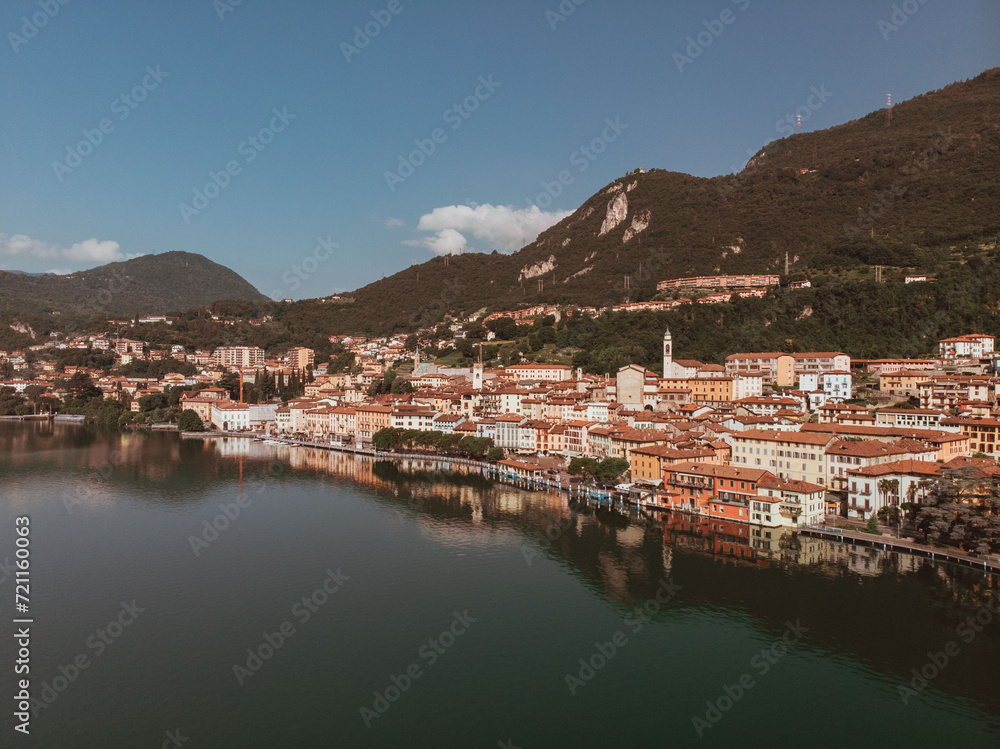 Aerial drone view of Lovere, a small Italian town located on the shores of Lake Iseo in Lombardy. The day is sunny and clear during a summer morning