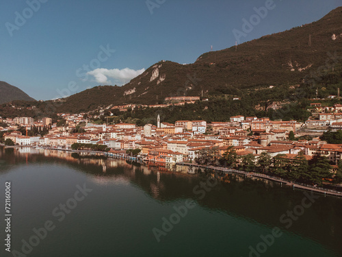Aerial drone view of Lovere, a small Italian town located on the shores of Lake Iseo in Lombardy. The day is sunny and clear during a summer morning