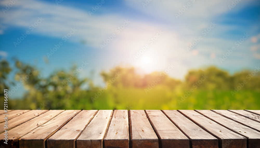 Fototapeta premium wood board table in front of summer landscape with lens flare. picture for background purpose