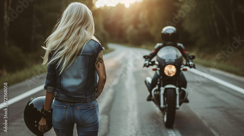 Blond woman holding helmet